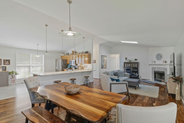 7115 Littlejohn Ln, Fairview, TN 37062 - dining room featuring vaulted ceiling, dark wood finished floors, and a fireplace