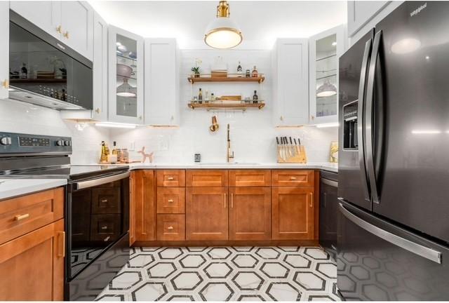2083 Stokes Ln, Nashville, TN 37215 - kitchen with black appliances, light countertops, and white cabinetry
