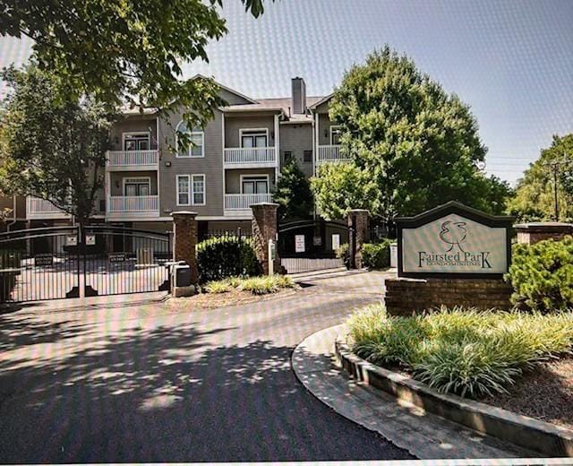 2083 Stokes Ln, Nashville, TN 37215 - view of asphalt road with a gated entry and curbs