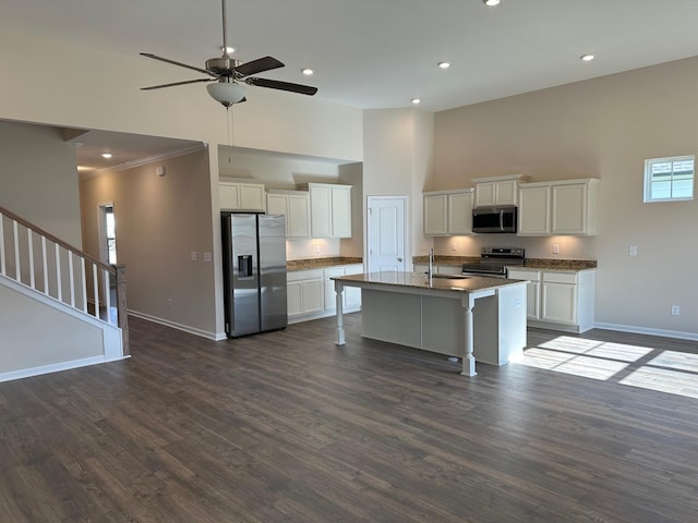 1004 Wiseman Farm Rd, Fairview, TN 37062 - kitchen with stainless steel appliances, a high ceiling, a ceiling fan, white cabinets, and a breakfast bar