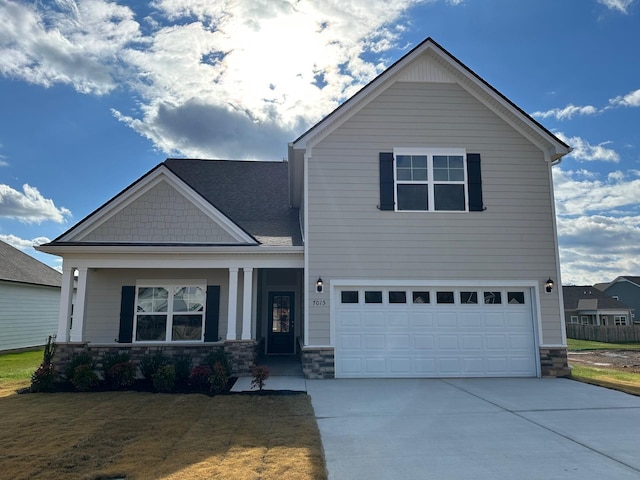 1004 Wiseman Farm Rd, Fairview, TN 37062 - craftsman-style home featuring a garage, stone siding, driveway, and covered porch