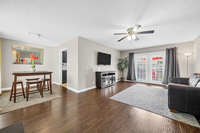 344 Pioneer Dr, Oak Grove, KY 42262 - living room featuring dark wood finished floors, ceiling fan, a textured ceiling, and a fireplace