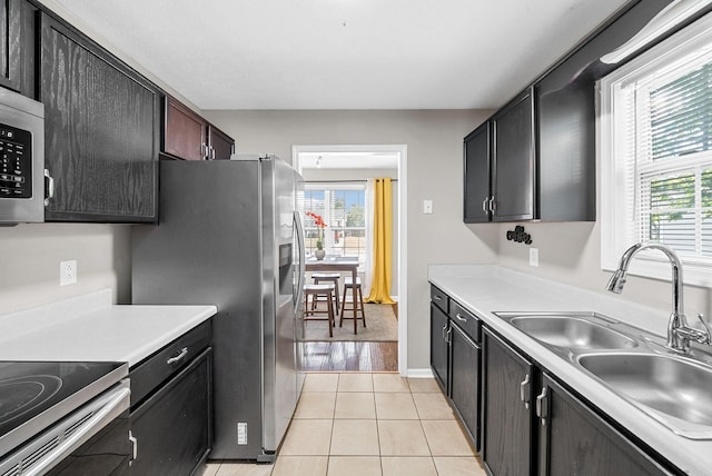 344 Pioneer Dr, Oak Grove, KY 42262 - kitchen featuring stainless steel appliances, healthy amount of natural light, light countertops, and light tile patterned floors