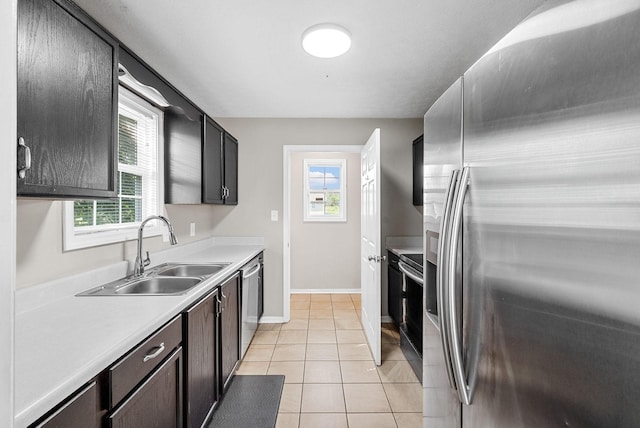 344 Pioneer Dr, Oak Grove, KY 42262 - kitchen featuring appliances with stainless steel finishes, light countertops, healthy amount of natural light, and light tile patterned flooring