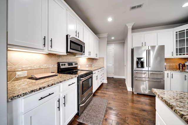 230 Fowler Cir, Franklin, TN 37064 - kitchen with appliances with stainless steel finishes, ornamental molding, white cabinetry, recessed lighting, and backsplash
