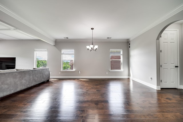 230 Fowler Cir, Franklin, TN 37064 - unfurnished living room featuring arched walkways, dark wood-style floors, a chandelier, ornamental molding, and a fireplace