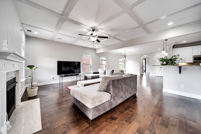 230 Fowler Cir, Franklin, TN 37064 - living room with ceiling fan, coffered ceiling, arched walkways, a high end fireplace, and dark wood-style floors