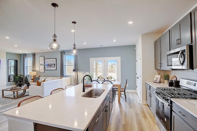 286 Subban Ct, Lebanon, TN 37087 - kitchen with stainless steel appliances, a center island with sink, light wood-style flooring, recessed lighting, and open floor plan