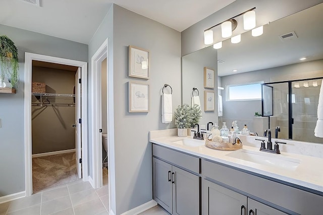 286 Subban Ct, Lebanon, TN 37087 - bathroom featuring double vanity, a stall shower, a spacious closet, and tile patterned floors
