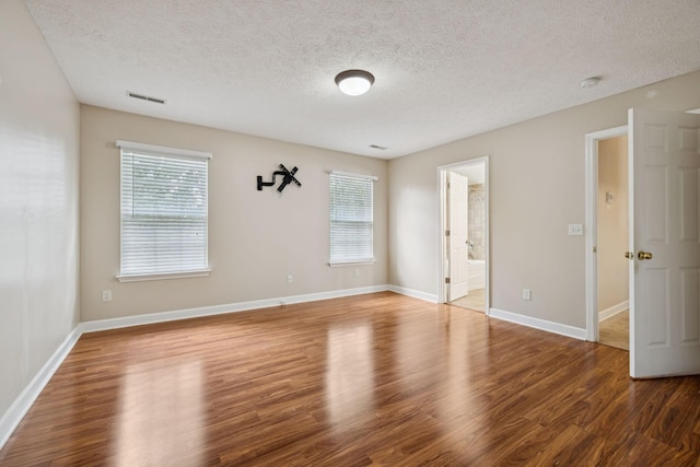 7023 Timber Oak Dr, Mount Juliet, TN 37122 - empty room with plenty of natural light, a textured ceiling, and wood finished floors