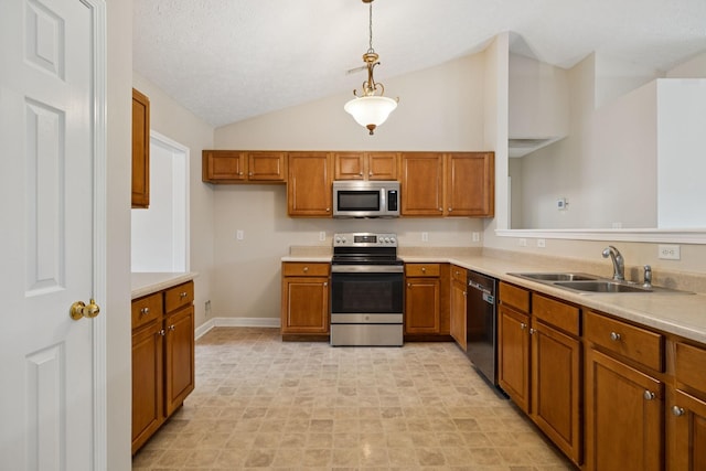 7023 Timber Oak Dr, Mount Juliet, TN 37122 - kitchen with stainless steel appliances, lofted ceiling, brown cabinetry, light countertops, and hanging light fixtures