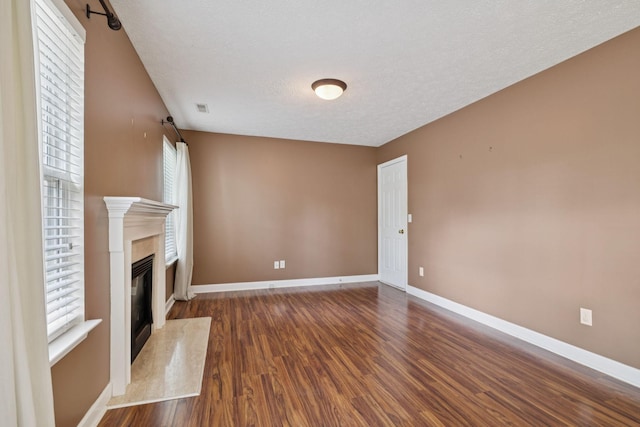 7023 Timber Oak Dr, Mount Juliet, TN 37122 - unfurnished living room with wood finished floors, a premium fireplace, and a textured ceiling