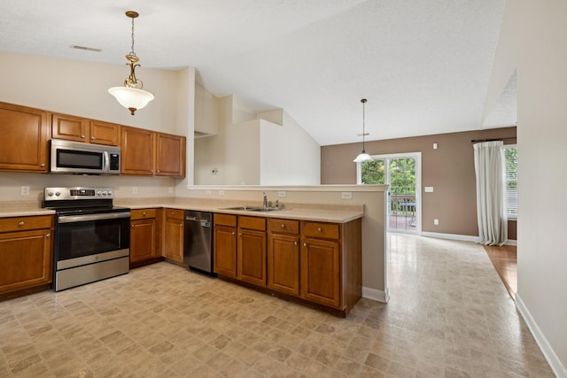 7023 Timber Oak Dr, Mount Juliet, TN 37122 - kitchen featuring appliances with stainless steel finishes, brown cabinetry, light countertops, a peninsula, and high vaulted ceiling