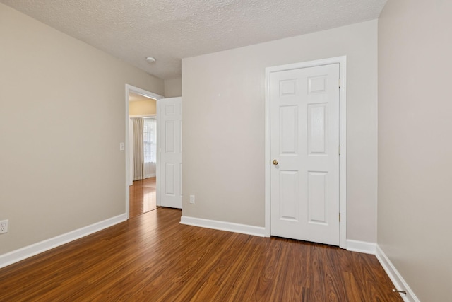 7023 Timber Oak Dr, Mount Juliet, TN 37122 - unfurnished bedroom with dark wood-style flooring and a textured ceiling