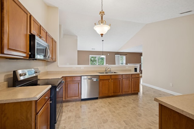 7023 Timber Oak Dr, Mount Juliet, TN 37122 - kitchen featuring appliances with stainless steel finishes, a peninsula, brown cabinetry, light countertops, and decorative light fixtures
