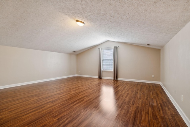 7023 Timber Oak Dr, Mount Juliet, TN 37122 - additional living space with a textured ceiling, dark wood-type flooring, and lofted ceiling