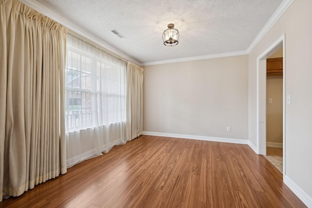 7023 Timber Oak Dr, Mount Juliet, TN 37122 - spare room featuring a textured ceiling, wood finished floors, ornamental molding, and a chandelier