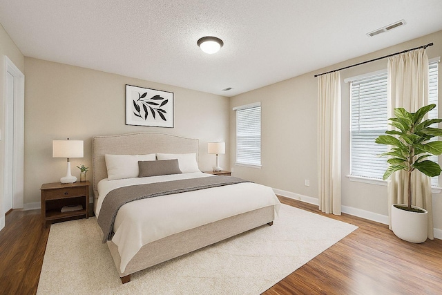 7023 Timber Oak Dr, Mount Juliet, TN 37122 - bedroom featuring wood finished floors, multiple windows, and a textured ceiling