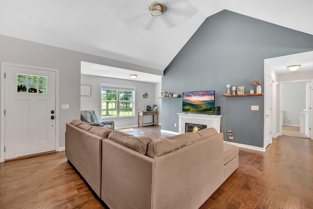 1105 Smiley Troutt Rd, Bethpage, TN 37022 - living room with high vaulted ceiling, wood finished floors, a glass covered fireplace, and a ceiling fan
