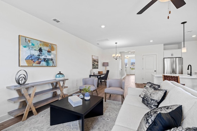 6051 Mill Tree Ct, Nashville, TN 37221 - living room featuring light wood-style flooring, a chandelier, recessed lighting, and a ceiling fan