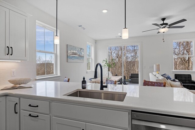 6051 Mill Tree Ct, Nashville, TN 37221 - kitchen featuring dishwasher, light countertops, open floor plan, white cabinets, and pendant lighting