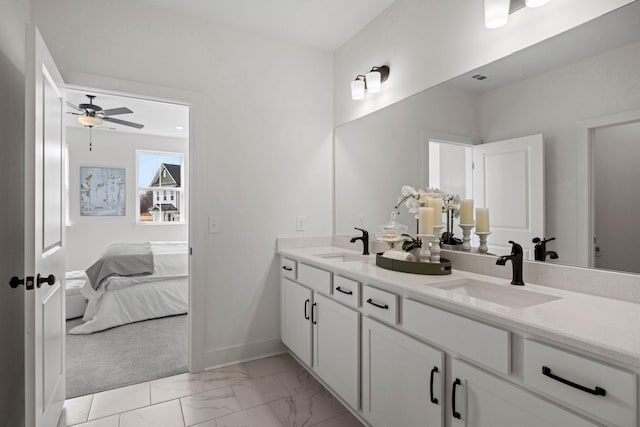 6051 Mill Tree Ct, Nashville, TN 37221 - bathroom with double vanity, connected bathroom, marble look tiles, and a ceiling fan