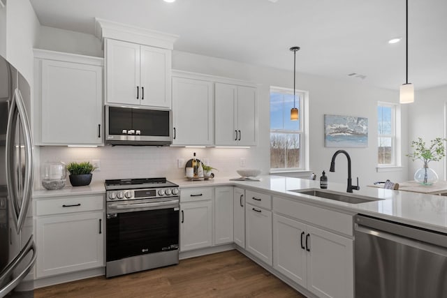 6051 Mill Tree Ct, Nashville, TN 37221 - kitchen with appliances with stainless steel finishes, tasteful backsplash, light countertops, white cabinetry, and decorative light fixtures