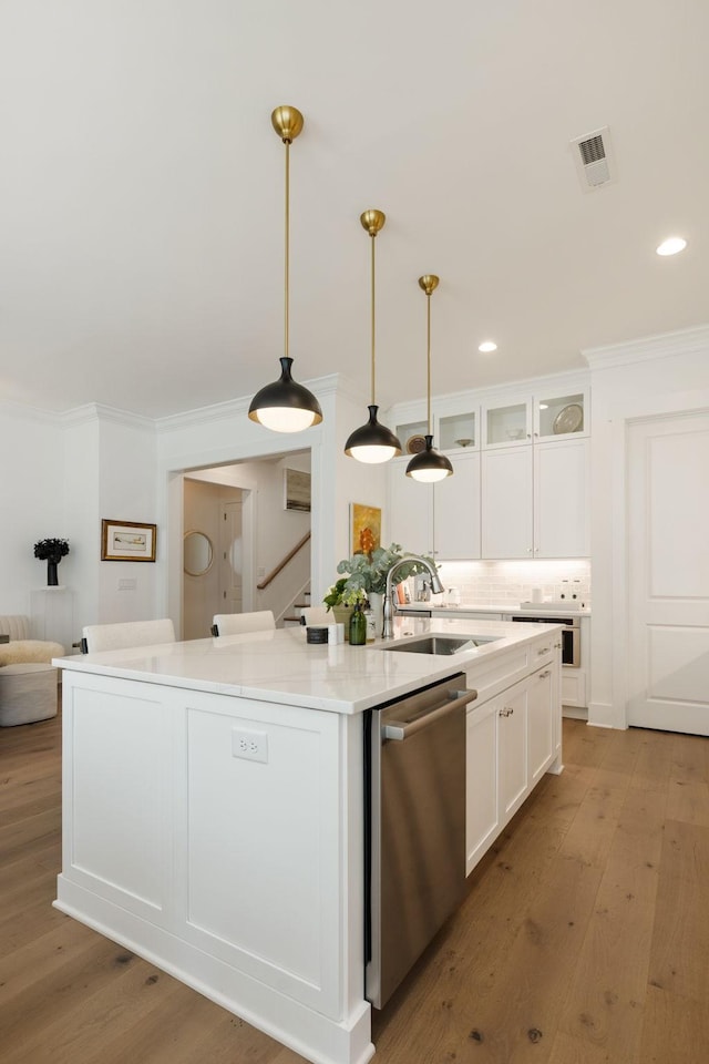 7019 Bolton St, Franklin, TN 37064 - kitchen featuring stainless steel dishwasher, white cabinetry, crown molding, an island with sink, and light wood-type flooring