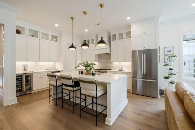 7019 Bolton St, Franklin, TN 37064 - kitchen featuring freestanding refrigerator, wine cooler, decorative backsplash, light wood finished floors, and recessed lighting