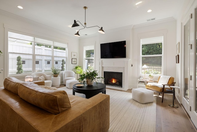 7019 Bolton St, Franklin, TN 37064 - living area featuring light wood-style flooring, a fireplace with flush hearth, ornamental molding, and recessed lighting
