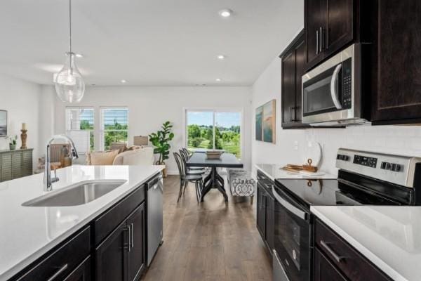 2202 Melk Ln, Columbia, TN 38401 - kitchen with appliances with stainless steel finishes, light countertops, recessed lighting, dark wood-style flooring, and open floor plan