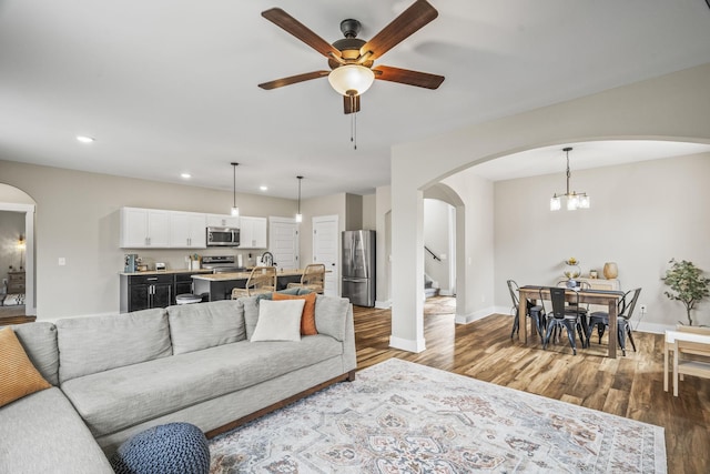 2015 Morgan Ct, Springfield, TN 37172 - living room featuring arched walkways, stairway, recessed lighting, ceiling fan, and wood finished floors