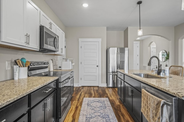 2015 Morgan Ct, Springfield, TN 37172 - kitchen featuring appliances with stainless steel finishes, dark cabinetry, arched walkways, white cabinets, and recessed lighting