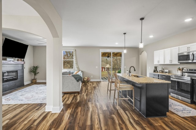 2015 Morgan Ct, Springfield, TN 37172 - kitchen with appliances with stainless steel finishes, ceiling fan, open floor plan, dark wood-style floors, and white cabinetry