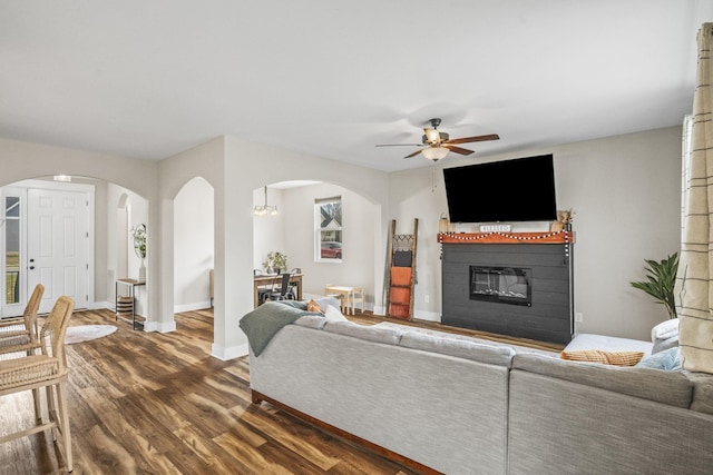 2015 Morgan Ct, Springfield, TN 37172 - living area with arched walkways, a ceiling fan, dark wood-style flooring, and a glass covered fireplace