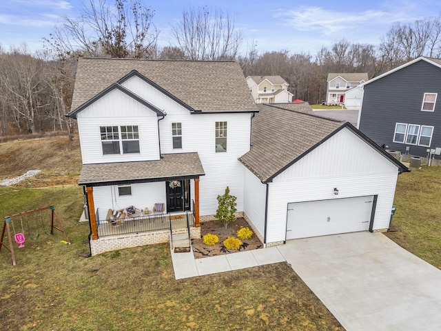 2015 Morgan Ct, Springfield, TN 37172 - view of front of home featuring a shingled roof, driveway, an attached garage, and covered porch