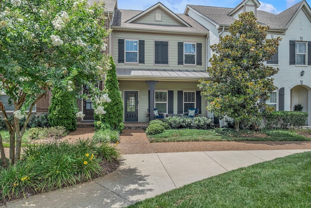 4029 Viola Ln, Franklin, TN 37069 - view of front of home featuring a porch, brick siding, a shingled roof, and a standing seam roof