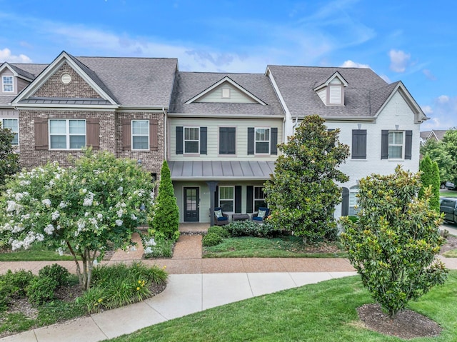 4029 Viola Ln, Franklin, TN 37069 - view of front of home featuring a porch, a shingled roof, brick siding, and a front lawn