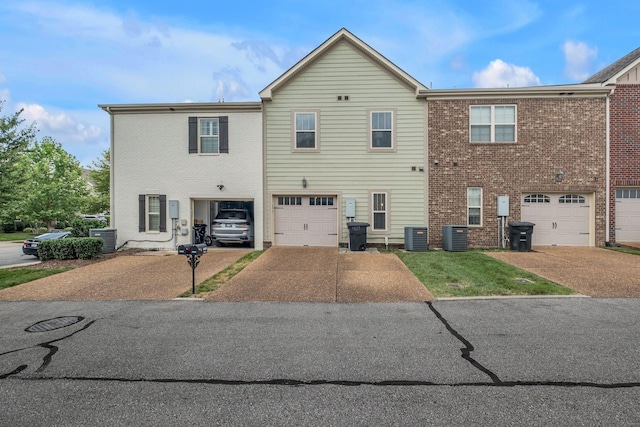 4029 Viola Ln, Franklin, TN 37069 - rear view of house featuring driveway, an attached garage, and brick siding