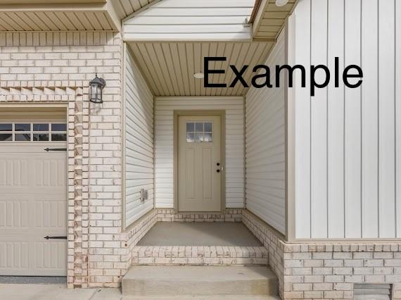 153 Irish Hls, Clarksville, TN 37042 - entrance to property with a garage, brick siding, and board and batten siding