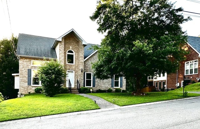 6545 Chessington Dr, Nashville, TN 37221 - view of front of house with brick siding, a front yard, and a shingled roof