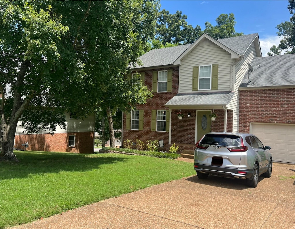 2532 Edinburgh St, Old Hickory, TN 37138 - traditional-style house featuring driveway, roof with shingles, a front yard, and brick siding