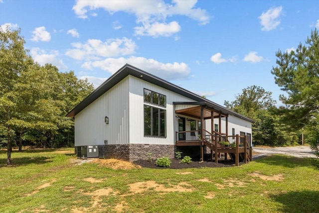 2006 Goodrich Rd, Nunnelly, TN 37137 - view of side of property featuring a yard, a deck, and stone siding