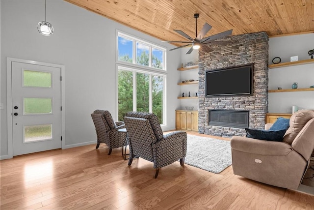 2006 Goodrich Rd, Nunnelly, TN 37137 - living area with wood ceiling, ceiling fan, a stone fireplace, light wood-type flooring, and high vaulted ceiling