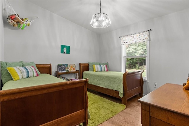 2006 Goodrich Rd, Nunnelly, TN 37137 - bedroom featuring a chandelier and light wood-style flooring