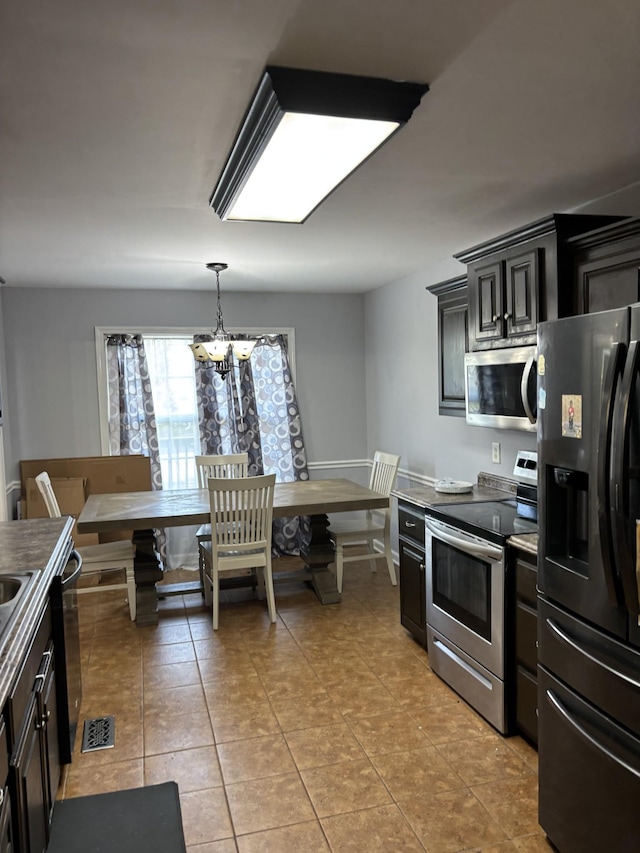 809 Renaissance Ave, Murfreesboro, TN 37129 - kitchen with appliances with stainless steel finishes, a chandelier, light tile patterned flooring, and pendant lighting