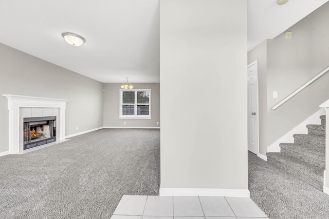 1373 Mackenzie Ct, Clarksville, TN 37042 - unfurnished living room featuring carpet flooring, stairway, a fireplace, and a chandelier