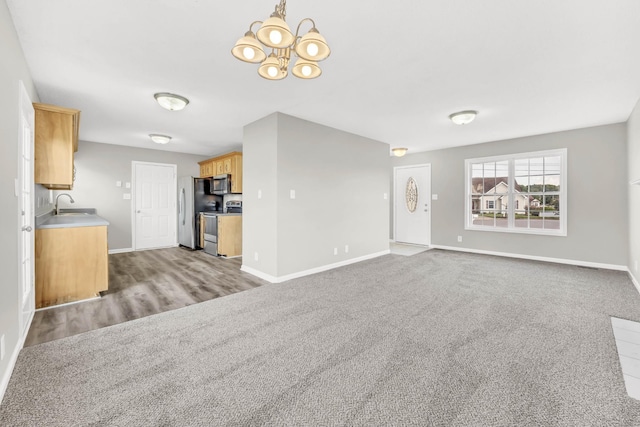 1373 Mackenzie Ct, Clarksville, TN 37042 - unfurnished living room featuring a chandelier and carpet flooring