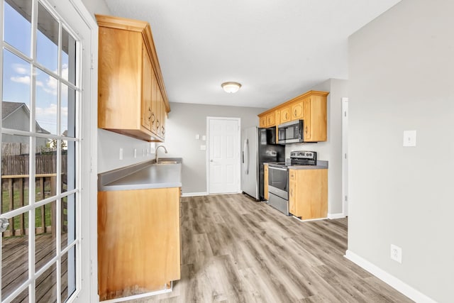 1373 Mackenzie Ct, Clarksville, TN 37042 - kitchen with appliances with stainless steel finishes, light wood finished floors, and light brown cabinets