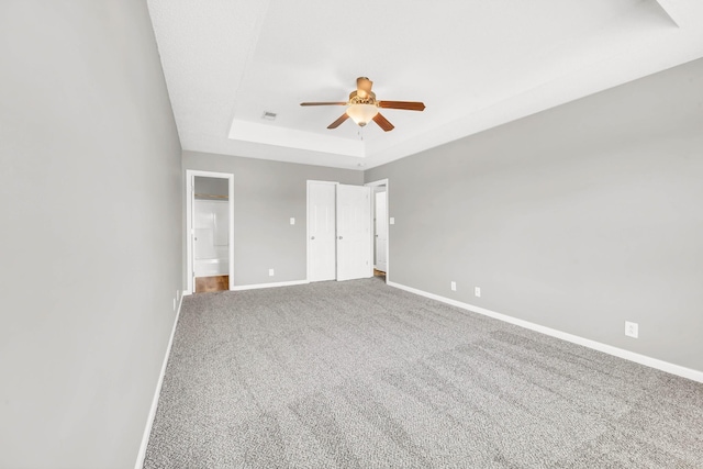 1373 Mackenzie Ct, Clarksville, TN 37042 - unfurnished bedroom with a tray ceiling, carpet, connected bathroom, and ceiling fan